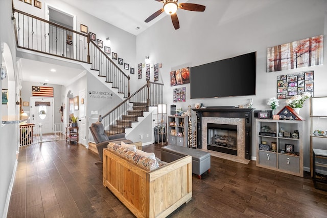 1438 Millet Dr, Clarksville, TN 37040 - living area featuring a high ceiling, ceiling fan, dark wood-type flooring, a premium fireplace, and stairway