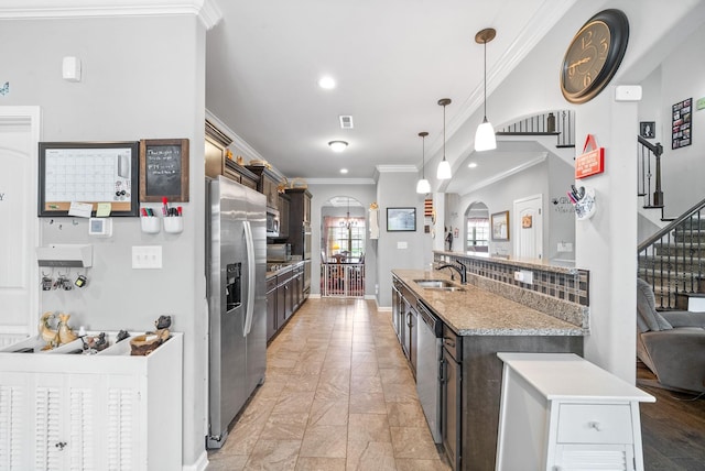 1438 Millet Dr, Clarksville, TN 37040 - kitchen featuring stainless steel appliances, arched walkways, a sink, crown molding, and dark brown cabinets