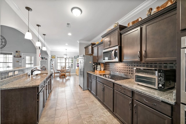 1438 Millet Dr, Clarksville, TN 37040 - kitchen with stainless steel appliances, dark brown cabinetry, decorative backsplash, ornamental molding, and a sink