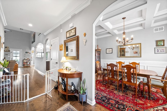 1438 Millet Dr, Clarksville, TN 37040 - dining area featuring arched walkways, a chandelier, wood finished floors, coffered ceiling, and beamed ceiling