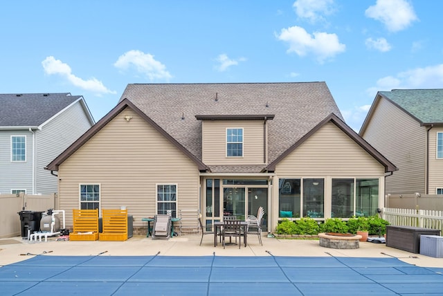 1438 Millet Dr, Clarksville, TN 37040 - back of property featuring a fire pit, a sunroom, a patio area, and a shingled roof