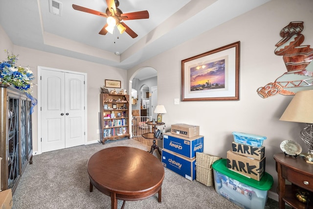 1438 Millet Dr, Clarksville, TN 37040 - sitting room with carpet floors, arched walkways, a ceiling fan, a tray ceiling, and baseboards
