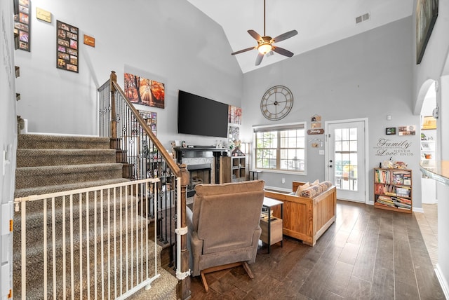 1438 Millet Dr, Clarksville, TN 37040 - living area featuring dark wood-style flooring, ceiling fan, high vaulted ceiling, a fireplace, and stairs