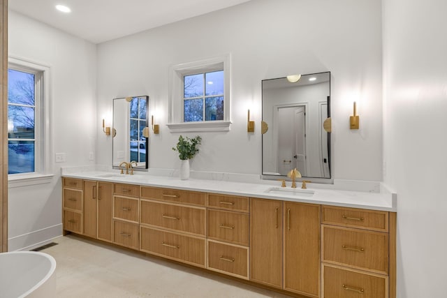 full bathroom featuring double vanity, visible vents, and a sink