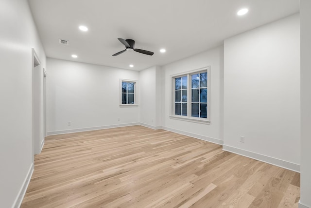 empty room with light wood-style flooring, visible vents, recessed lighting, and ceiling fan