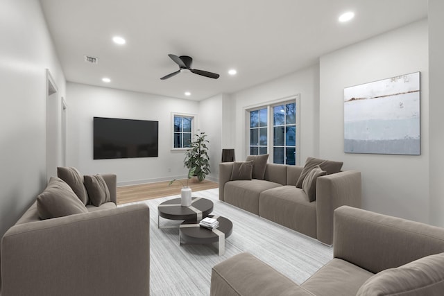 living room featuring baseboards, visible vents, recessed lighting, a ceiling fan, and wood finished floors