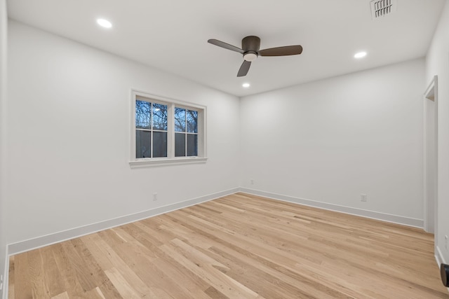 unfurnished room with light wood-type flooring, visible vents, baseboards, and ceiling fan