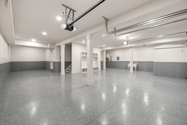 garage featuring a wainscoted wall and a garage door opener