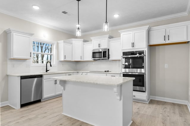 998 Alton Dr, Clarksville, TN 37043 - kitchen featuring backsplash, light wood-style floors, appliances with stainless steel finishes, and white cabinetry