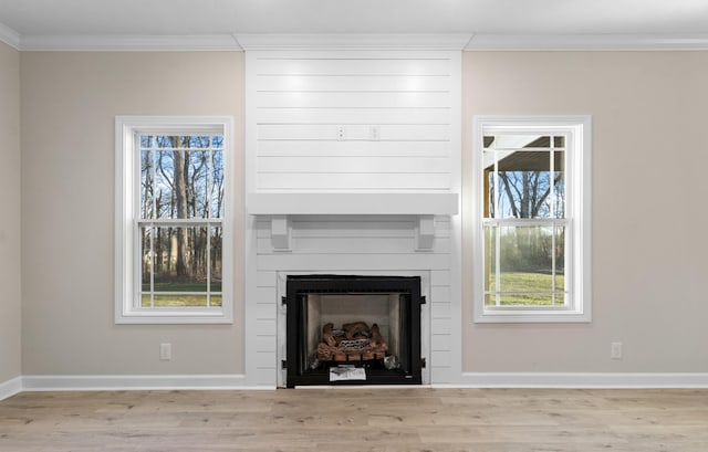 998 Alton Dr, Clarksville, TN 37043 - unfurnished living room featuring baseboards, wood finished floors, a large fireplace, and ornamental molding