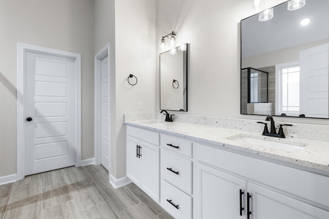 998 Alton Dr, Clarksville, TN 37043 - full bath featuring baseboards, a sink, a shower stall, and double vanity