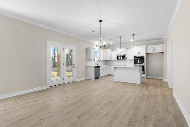 998 Alton Dr, Clarksville, TN 37043 - kitchen with a chandelier, light wood-type flooring, stainless steel appliances, light countertops, and ornamental molding
