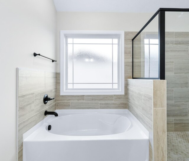 998 Alton Dr, Clarksville, TN 37043 - bathroom featuring a bath and a tile shower