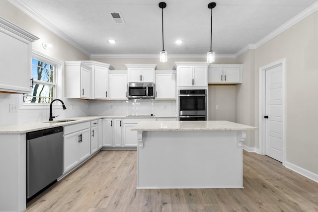 998 Alton Dr, Clarksville, TN 37043 - kitchen featuring appliances with stainless steel finishes, tasteful backsplash, a sink, and white cabinetry