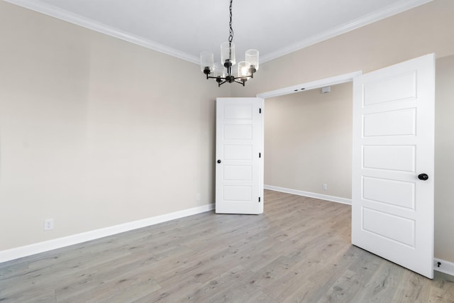 998 Alton Dr, Clarksville, TN 37043 - unfurnished room featuring light wood-style flooring, baseboards, an inviting chandelier, and crown molding