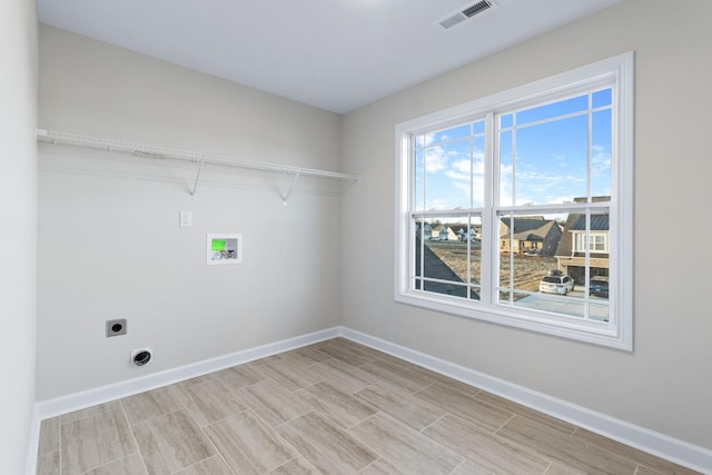 998 Alton Dr, Clarksville, TN 37043 - washroom featuring hookup for a washing machine, hookup for an electric dryer, visible vents, baseboards, and laundry area