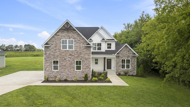 craftsman inspired home featuring a front lawn and stone siding