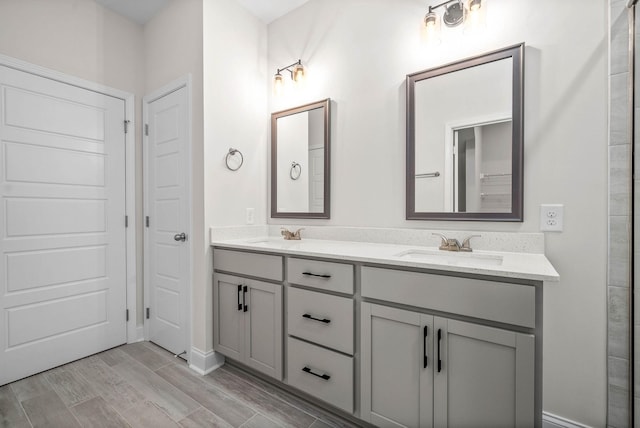 484 Herman Dr, Clarksville, TN 37042 - full bathroom with double vanity, baseboards, wood finished floors, and a sink