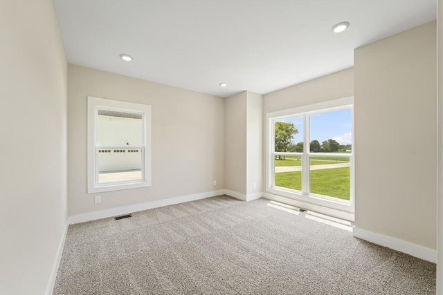 unfurnished room featuring recessed lighting, carpet, visible vents, and baseboards