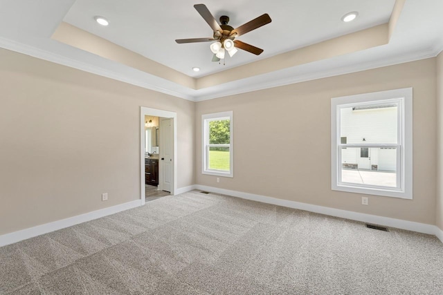 unfurnished bedroom with recessed lighting, a raised ceiling, visible vents, baseboards, and carpet flooring