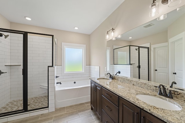 full bathroom with a garden tub, a sink, visible vents, and a stall shower