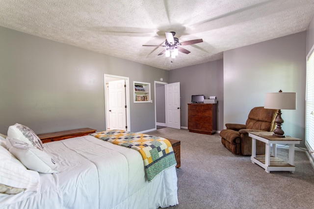 bedroom with carpet floors, a textured ceiling, baseboards, and ceiling fan