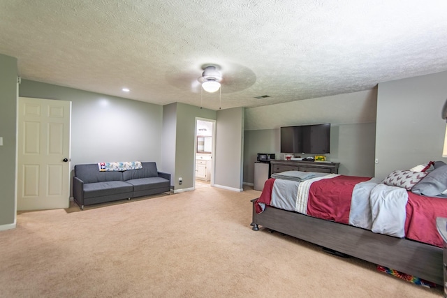 bedroom featuring baseboards, a textured ceiling, and light colored carpet