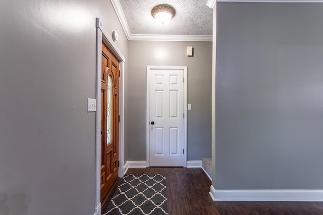 entrance foyer with baseboards, crown molding, wood finished floors, and a textured ceiling