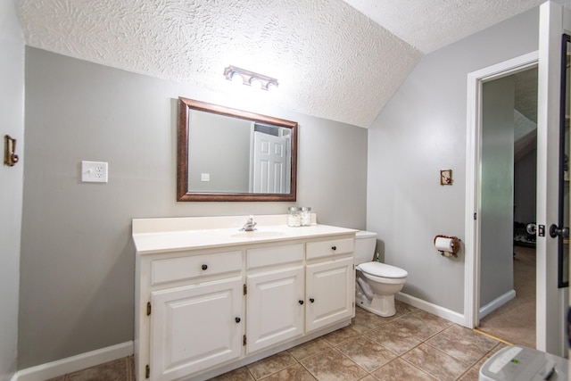 bathroom featuring a textured ceiling, vanity, baseboards, toilet, and lofted ceiling
