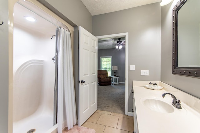full bathroom featuring a shower stall, a ceiling fan, tile patterned flooring, and vanity