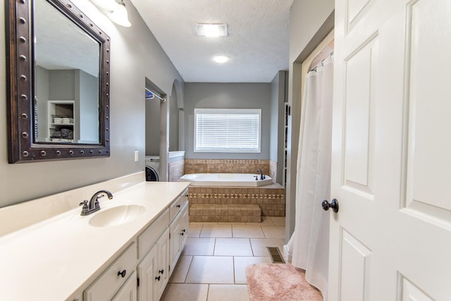 full bath featuring a bath, tile patterned floors, a textured ceiling, visible vents, and vanity