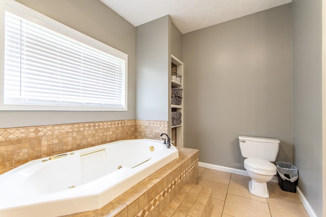 full bathroom featuring tile patterned flooring, baseboards, toilet, and a tub with jets