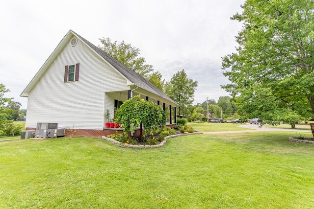 view of property exterior featuring a lawn and central AC unit