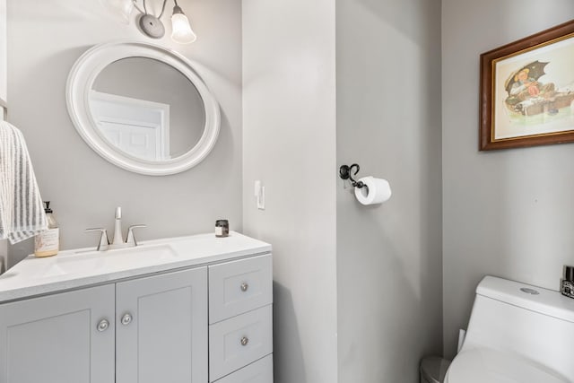 bathroom featuring toilet and vanity