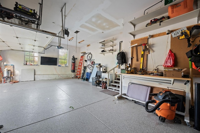 garage with a workshop area and a garage door opener