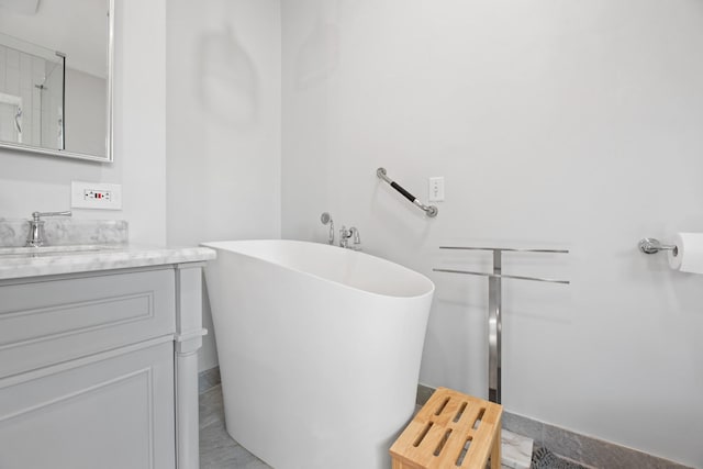 bathroom featuring a freestanding tub and vanity