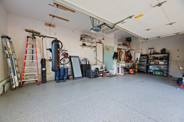 garage with a garage door opener and a workshop area