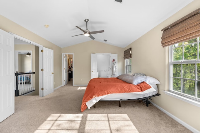 carpeted bedroom with lofted ceiling, multiple windows, and baseboards