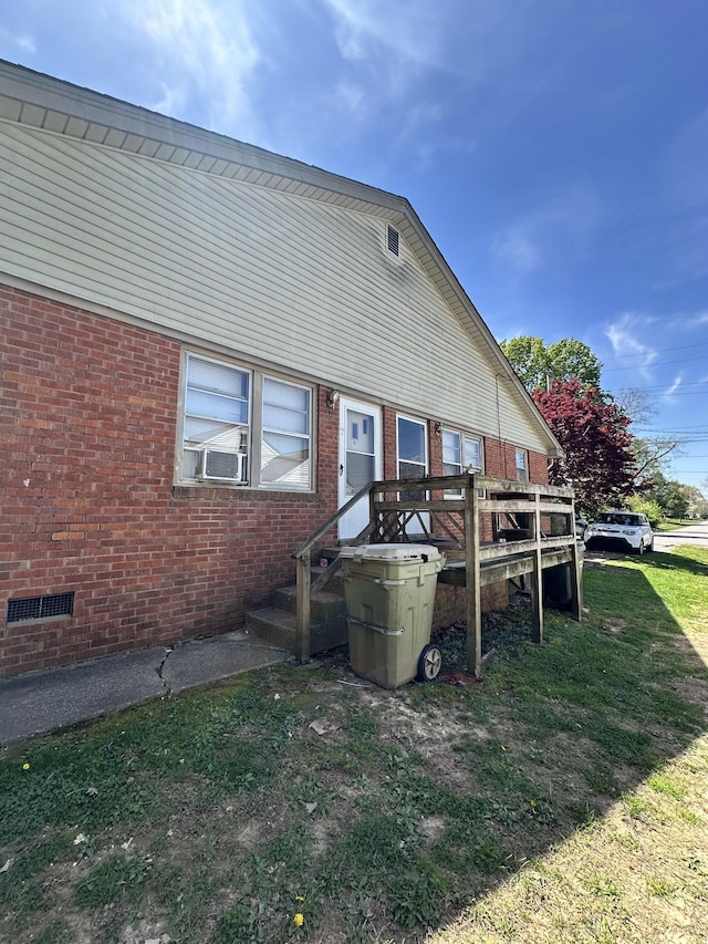 rear view of house with brick siding and cooling unit