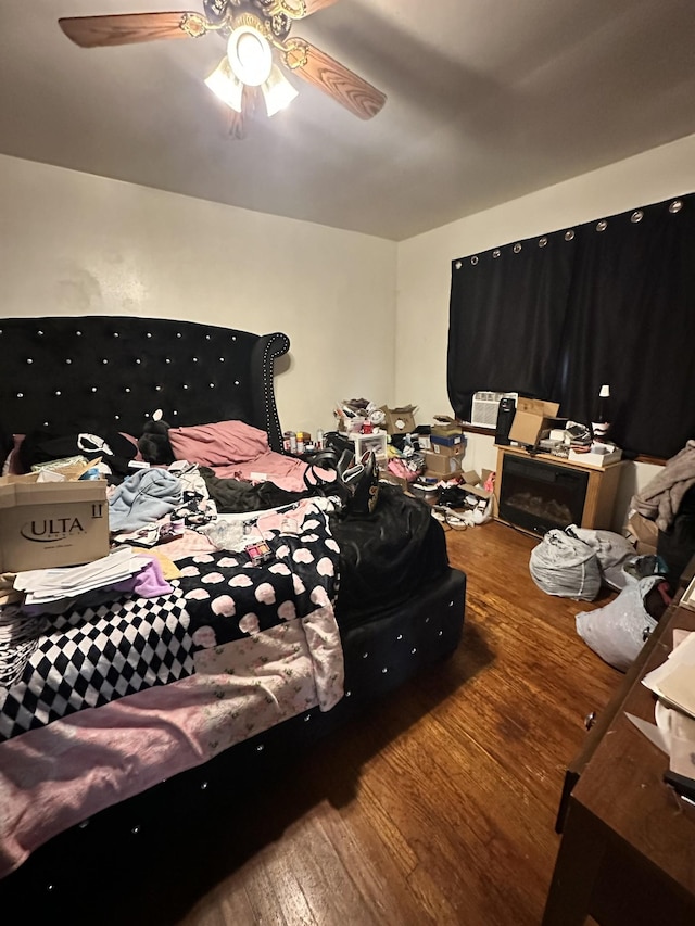 bedroom featuring a ceiling fan and wood finished floors