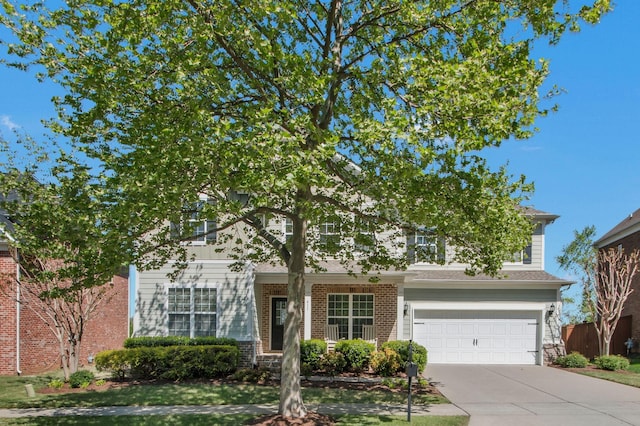 411 Valleyview Dr, Franklin, TN 37064 - view of property hidden behind natural elements with a garage, brick siding, and concrete driveway
