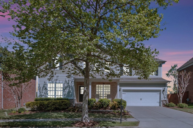 411 Valleyview Dr, Franklin, TN 37064 - obstructed view of property featuring brick siding, an attached garage, and driveway
