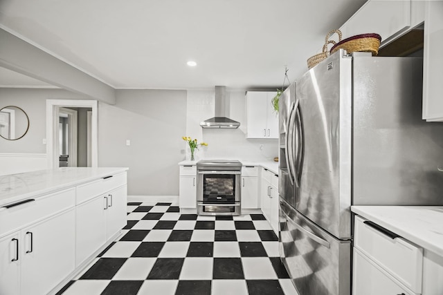 kitchen with wall chimney exhaust hood, stainless steel appliances, recessed lighting, white cabinetry, and dark floors