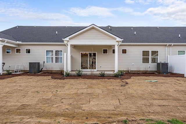 rear view of house with central AC, a patio, and fence