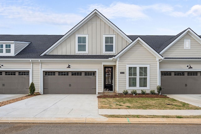 view of front of house featuring board and batten siding, driveway, roof with shingles, and a garage