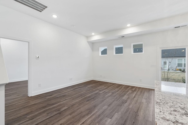 unfurnished room with baseboards, visible vents, recessed lighting, and dark wood-style floors