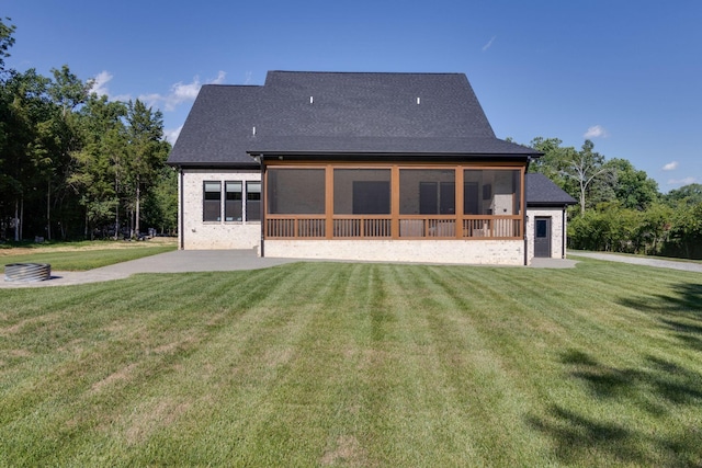back of house with a patio area, a sunroom, and a yard