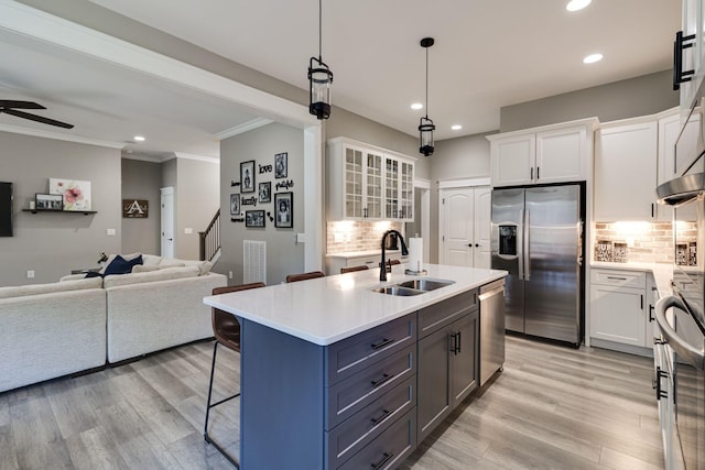 kitchen featuring recessed lighting, white cabinets, appliances with stainless steel finishes, and a sink