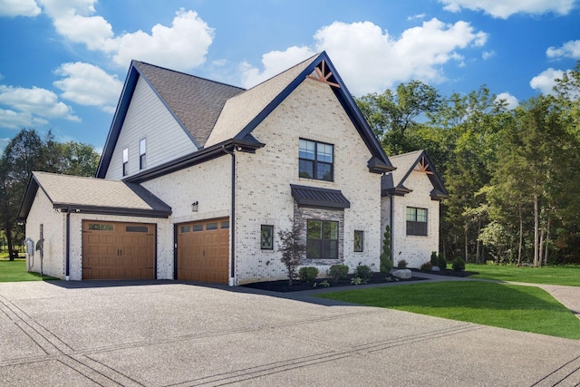 french country inspired facade with an attached garage, a front lawn, and aphalt driveway