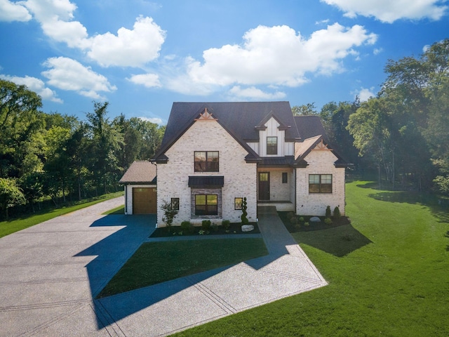 view of front of home with a front lawn, driveway, stone siding, board and batten siding, and a garage